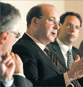  ?? PETER REDMAN / NATIONAL POST ?? Jack Mintz, centre, of the C.D. Howe Institute, speaks at an asset managers lunch in Toronto yesterday. Mr. Mintz said neutralizi­ng the tax structure would level the field between corporatio­ns and trusts.