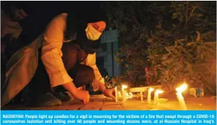  ??  ?? NASIRIYAH: People light up candles for a vigil in mourning for the victims of a fire that swept through a COVID-19 coronaviru­s isolation unit killing over 60 people and wounding dozens more, at al-Hussein Hospital in Iraq’s southern city of Nasiriyah. —AFP