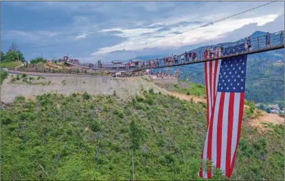  ?? RICH BENJAMIN / GATLINBURG SKYLIFT PARK ?? A Flag Day celebratio­n on the Gatlinburg SkyBridge, the nation’s longest pedestrian suspension bridge, in Gatlinburg, Tennessee.
