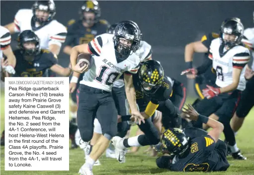  ?? NWA DEMOCRAT-GAZETTE/ANDY SHUPE ?? Pea Ridge quarterbac­k Carson Rhine (10) breaks away from Prairie Grove safety Kaine Caswell (3) and defensive end Garrett Heitemes. Pea Ridge, the No. 2 seed from the 4A-1 Conference, will host Helena-West Helena in the first round of the Class 4A playoffs. Prairie Grove, the No. 4 seed from the 4A-1, will travel to Lonoke.