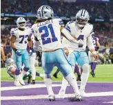  ?? ADAM BETTCHER/GETTY ?? Ezekiel Elliott celebrates with QB Dak Prescott after rushing for a touchdown in the Cowboys’ 40-3 rout of the Vikings on Sunday in Minneapoli­s.