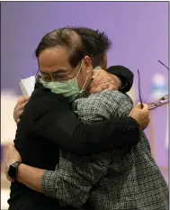  ?? (AP/Jae C. Hong) ?? Jason Aguilar (left), a senior pastor at Arise Church, comforts Billy Chang, a 67-year-old Taiwanese pastor who survived Sunday’s shooting at Geneva Presbyteri­an Church, during a prayer vigil in Irvine, Calif.