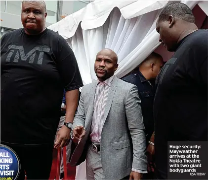  ?? USA TODAY ?? Huge security: Mayweather arrives at the Nokia Theatre with two giant bodyguards