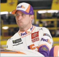  ?? Gerry Broome / Associated Press ?? Denny Hamlin climbs into his car to practice for the NASCAR Cup Series auto race at Charlotte Motor Speedway in Concord, N.C.