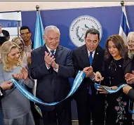  ?? AP/RONEN ZVULUN ?? Israeli Prime Minister Benjamin Netanyahu (second from left); his wife, Sara (beside him); and Guatemalan President Jimmy Morales (center) watch Wednesday as Morales’ wife Hilda Patricia Marroquin cuts the ribbon dedicating the Guatemalan Embassy in...