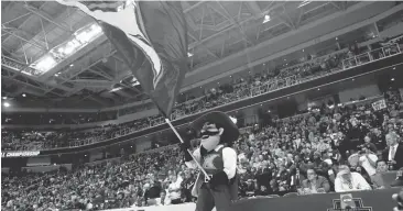  ?? NHATV. MEYER/STAFF ?? The Xavier Musketeers mascot waves a large flag before their game Thursday against the Arizona Wildcats in San Jose.