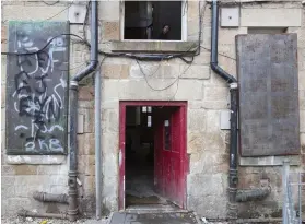  ??  ?? Slum-like conditions: Open doors and barred windows covered in graffiti blight some buildings, top. Right, pavements are full of stinking bins, broken furniture and debris