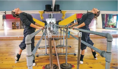  ??  ?? Helene Luna warms up before ballet practice Thursday at Dance Space Santa Fe as she prepares for her performanc­e Friday at the 94th annual burning of Zozobra.