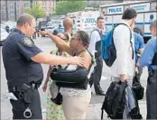  ?? TIMOTHY A. CLARY/GETTY-AFP ?? A woman talks to an officer after police responded to the shooting Friday at Bronx-Lebanon Hospital in New York.