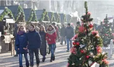  ?? — AFP ?? People gather at a Christmas market in the centre of Kiev.