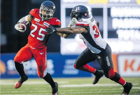  ?? JEFF MCINTOSH/THE CANADIAN PRESS ?? The Redblacks’ Kyries Hebert, right, takes exception for what he believes is a double standard regarding helmet hits in today’s CFL. He says defensive players tend to be targeted while offensive players who initiate contact with their helmets are given...