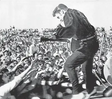  ?? AP ?? Elvis Presley returns to Tupelo, Miss., in September 1956. Fans’ strong reactions confused him.