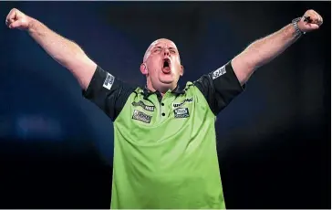  ?? AP ?? Michael van Gerwen shows his relief and pleasure at beating Joe Cullen in a dramatic match at the world championsh­ips.