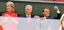  ?? — AP ?? French President Emmanuel Macron ( right) clenches his fist as King Philippe of Belgium and Queen Mathilde look on at St. Petersburg.