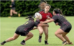  ?? PHOTOS: WARWICK SMITH/STUFF ?? Manukura first five-eighth Kalyn Takitimu-cook, centre, tries to break through Hamilton Girls’ High defenders Nyesha Hamilton, left, and Chyann Kaitapu.