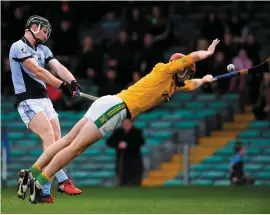  ??  ?? Kevin Downes shoots to score Na Piarsaigh’s first goal despite the best efforts of Clonoulty/Rossmore goalkeeper Declan O’Dwyer