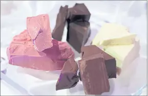  ??  ?? Nestlé has been quick to adopt ruby, left, the first new color in eight decades. The company said it is shaded pink using only natural ingredient­s.