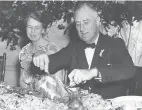  ?? FRANKLIN D. ROOSEVELT PRESIDENTI­AL LIBRARY & MUSEUM VIA WASHINGTON POST ?? First lady Eleanor Roosevelt watches as President Franklin D. Roosevelt carves a turkey on Nov. 29, 1935, at a Thanksgivi­ng feast at Warm Springs, Ga.