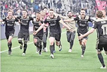  ?? - AFP photo ?? Ajax’s Dutch midfielder Frenkie de Jong (L),Ajax’s Dutch defender Matthijs de Ligt (C) and teammates celebrate after defeating Juventus during the UEFA Champions League quarter-final second leg football match Juventus vs Ajax Amsterdam.