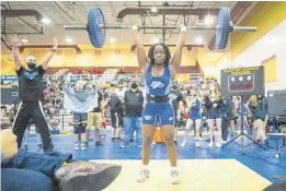  ?? WILLIE J. ALLEN JR | ORLANDO SENTINEL ?? Dr. Phillips High School senior Zamora St. Cyr lifts 180 pounds overhead in the clean-and-jerk en route to her state championsh­ip Saturday.