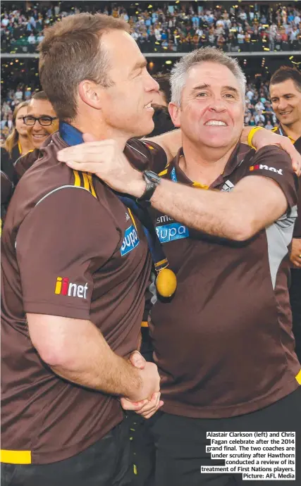  ?? Picture: AFL Media ?? Alastair Clarkson (left) and Chris Fagan celebrate after the 2014 grand final. The two coaches are under scrutiny after Hawthorn conducted a review of its treatment of First Nations players.