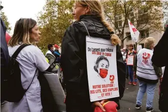  ?? Francois Mori / Associated Press ?? Health care workers protest a law requiring them to get vaccinated or risk suspension from their jobs outside the Health Ministry in Paris. As many as 300,000 are not vaccinated.