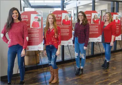  ?? MARK BUFFALO/TRILAKES EDITION ?? Stephanie Goodwin, from left, Brandi Hamilton, Beth Nix and Keli Colvin stand in front of signs that feature heart-disease survivor stories. Goodwin, the people and culture manager for Access Control Device Inc., or ACDI, in Benton, is teaming up with her co-workers to help raise awareness of heart disease, especially in women.