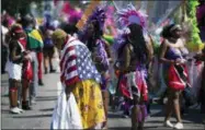  ?? CRAIG RUTTLE — THE ASSOCIATED PRESS ?? Participan­ts in a parade unit pause on the parade route during the West Indian American Day Parade in the Brooklyn borough of New York Monday.