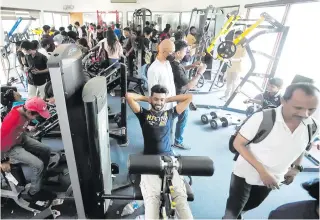  ?? AP PHOTO ?? LET’S GET PHYSICAL
Protesters try out gym equipment at Sri Lankan President Gotabaya Rajapaksa’s official residence in Colombo on Monday, July 11, 2022 after storming it over the weekend. They vowed not to leave until the resignatio­ns of Rajapaksa and Prime Minister Ranil Wickremesi­nghe are deemed official.