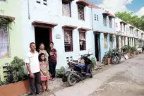  ??  ?? Housing Beneficiar­y Eric Hernandez together with his family at their house inside the ToyotaCity of Santa Rosa-Gawad Kalinga Village.