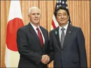  ?? EUGENE HOSHIKO / AP ?? Vice President Mike Pence and Japanese Prime Minister Shinzo Abe shake hands Tuesday before a lunch at Abe’s official residence in Tokyo. Pence told Abe the U.S. has run out of patience with Pyongyang.