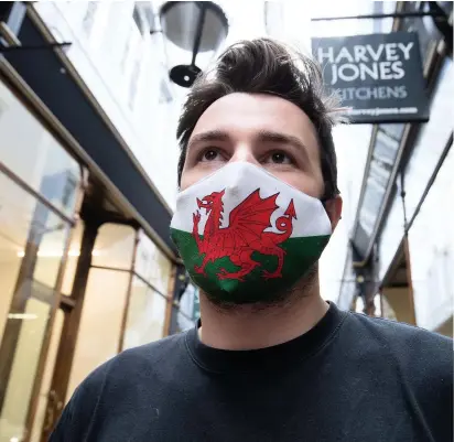  ?? GARETH EVERETT ?? Mask-wearing in public places will remain the law in Wales, despite changes that are due to come into effect in England later this month