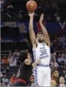  ?? CHUCK BURTON — THE ASSOCIATED PRESS ?? North Carolina’s Luke Maye (32) shots over Louisville’s Jordan Nwora (33) duringACC tournament in Charlotte, N.C.