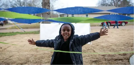  ?? Staff photo by Hunt Mercier ?? ■ Ayden Blair celebrates the new home he and has family will move into Friday in Texarkana, Ark. Habitat for Humanity of Texarkana held a blessing and dedication for the first time on the Arkansas side for the Blair family home.