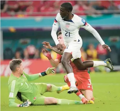  ?? DARKO VOJINOVIC/AP ?? Tim Weah scores in the first half but the U.S. settled for a draw in its World Cup group-play opener vs. Wales on Monday.