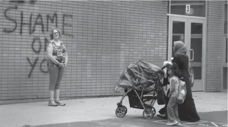  ?? ANDREW FRANCIS WALLACE/TORONTO STAR FILE PHOTO ?? Sue Mabey, outside Thorncliff­e last month, says graffiti sprayed on the wall was “devastatin­g” for the school and staff morale and spirit.