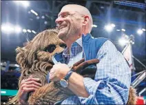  ??  ?? Thunder chairman Clay Bennett gets a hug from mascot Rumble the Bison during an Oct. 25 game against the Wizards.