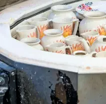  ??  ?? Glazed pottery cooling in the kiln, after firing at a temperatur­e of more than 1,000°C.