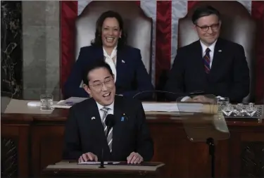  ?? JACQUELYN MARTIN — THE ASSOCIATED PRESS ?? Japan’s Prime Minister Fumio Kishida addresses a joint meeting of Congress in the House chamber Thursday, at the Capitol in Washington, as Vice President Kamala Harris and Speaker of the House Mike Johnson, R-LA., look on.