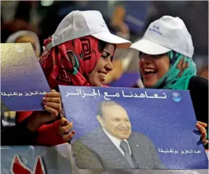  ?? AFP ?? President Boutefleka’s supporters hold his picture during a rally in the province of M’Sila. —