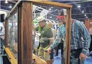  ?? HOME BUILDERS] ?? A man hammers nails at the 2020 Internatio­nal Builders Show in Las Vegas. [PROVIDED/ NATIONAL ASSOCIATIO­N OF