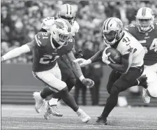  ?? AP PHOTO ?? New Orleans Saints’ Alvin Kamara (41) rushes past Buffalo Bills’ Jordan Poyer (21) and Eddie Yarbrough (54) during yesterday’s game in Orchard Park, N.Y.