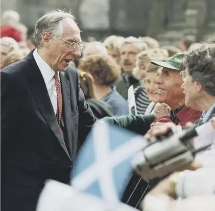  ??  ?? 0 Donald Dewar speaks to people on the Royal Mile on the day the Scottish Parliament opened in 1999