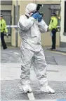  ??  ?? A forensics officer gathering evidence during the investigat­ion into the death of Kimberley MacKenzie.