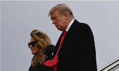  ?? Photograph: Andrew Caballero-Reynolds/AFP/Getty Images ?? Donald Trump and the first lady step off Air Force One at Andrews base on Thursday. The president had reportedly been in a stormy mood since his arrival at Mar-a-Lago.