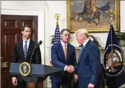  ?? ZACH GIBSON / POOL ?? David Perdue (center), R-Ga., and Sen. Tom Cotton (left), R-Ark., have come to be seen as a barometer for President Donald Trump (right) on immigratio­n.