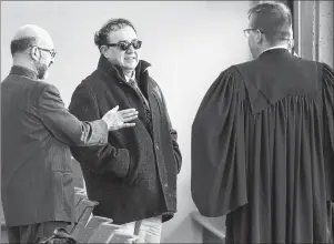  ?? CP PHOTO ?? Seyed Mirsaeid-Ghazi talks with his lawyer, Luke Craggs, right, through his translator, left, at Nova Scotia Supreme Court in Halifax on Thursday. Mirsaeid-Ghazi, a city taxi driver, is accused of sexually assaulting a female passenger.