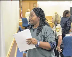  ?? KENT D. JOHNSON / AJC ?? Therian Wimbush leaves court during a break in a bond hearing in August 2014. Wimbush has claimed that a seven-count indictment against her husband, Recardo, and her was fraudulent. She has been acting as her own attorney in the child-abuse case.