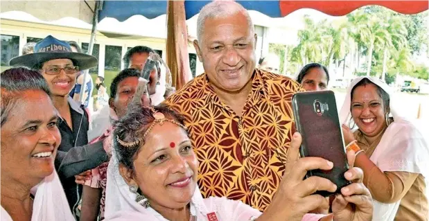  ??  ?? Fijian Prime Minister Voreqe Bainimaram­a poses for selfies with the crowd at the Fiji Girmit Remembranc­e Day celebratio­ns at Albert Park, Suva, on Saturday, May 11, 2019.