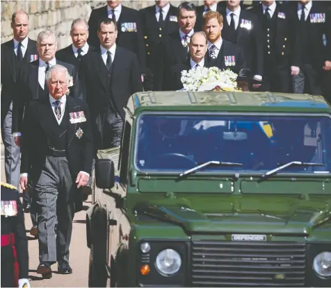  ?? LEON NEAL/WPA POOL/GETTY IMAGES ?? Members of the Royal family, led by a sombre Prince Charles, follow the Land Rover carrying Prince Philip's coffin on Saturday at Windsor Castle. Only 30 guests were invited due to pandemic restrictio­ns.